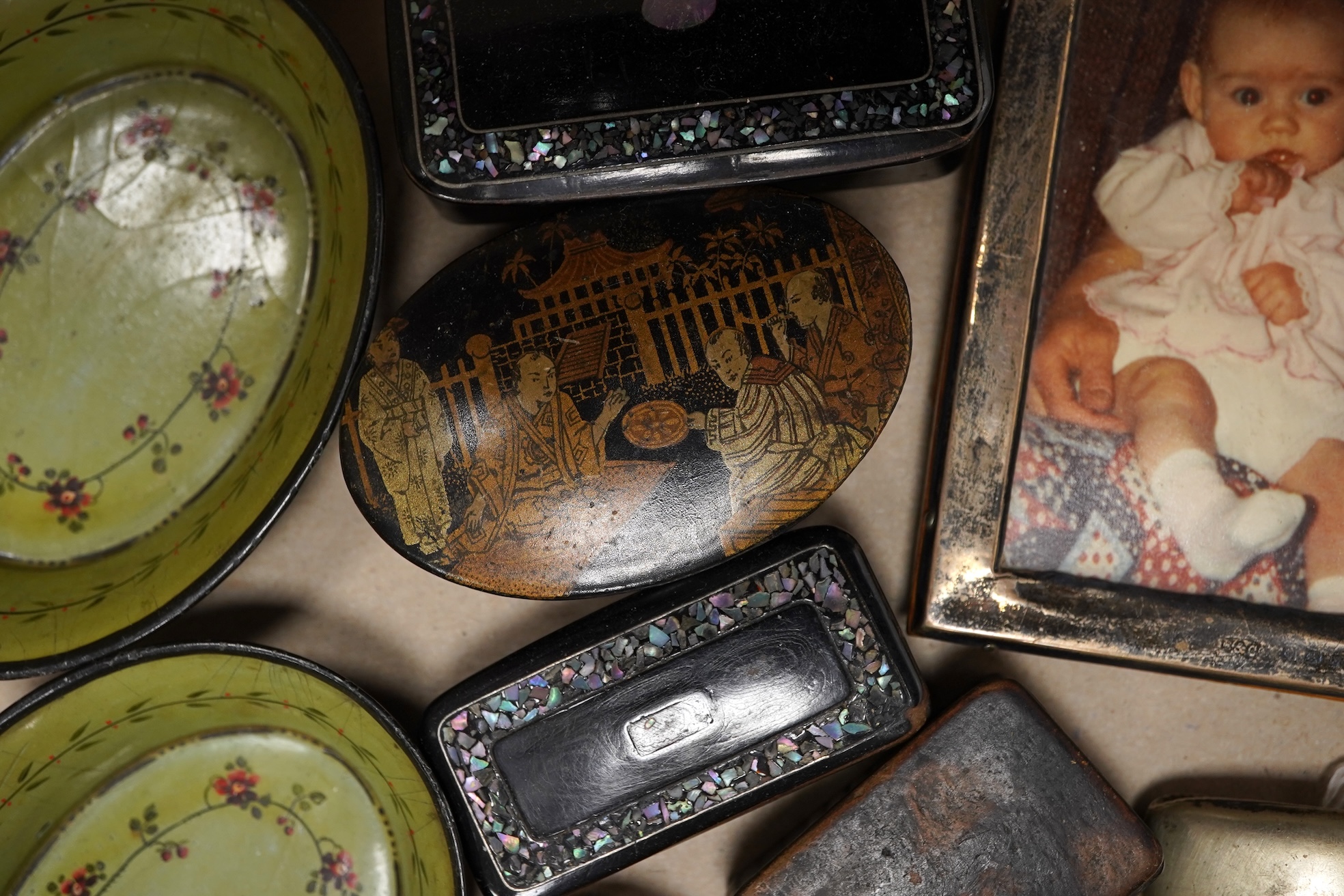 A collection of objects of vertu including snuff boxes, a pair of miniature oval trays, a silver mounted clock and photo frame, etc.